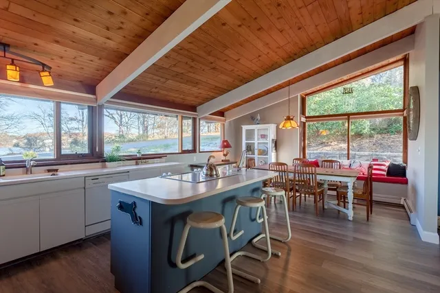a kitchen with lots of counter and a view of dining room
