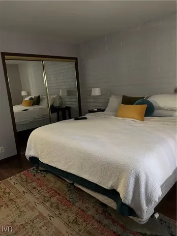 a bedroom with a bed and mirror