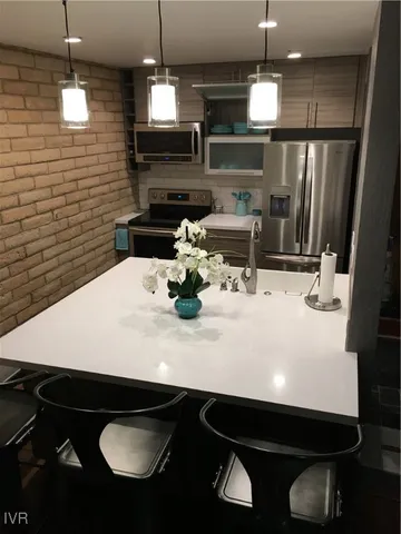 a kitchen with a sink stainless steel appliances and cabinets