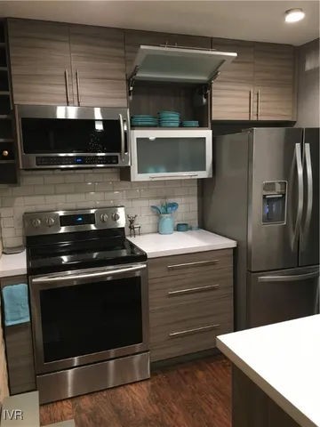 a kitchen with stainless steel appliances and wooden cabinets