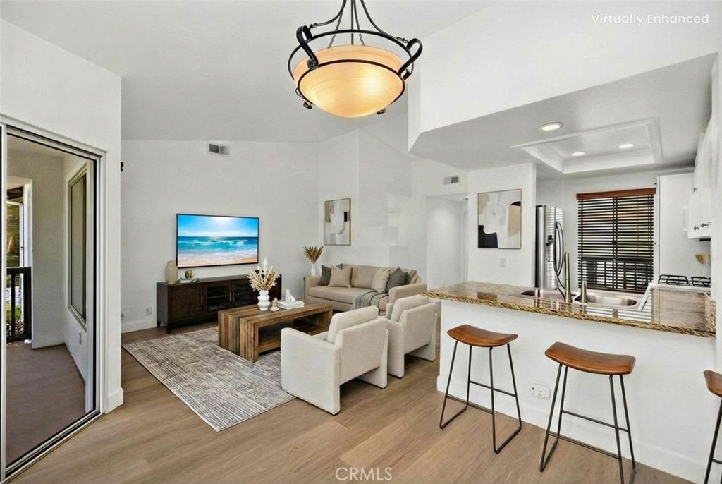 a living room with furniture and a chandelier
