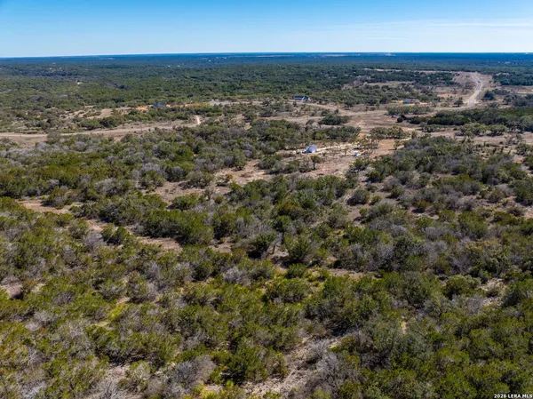 an aerial view of residential houses with city view