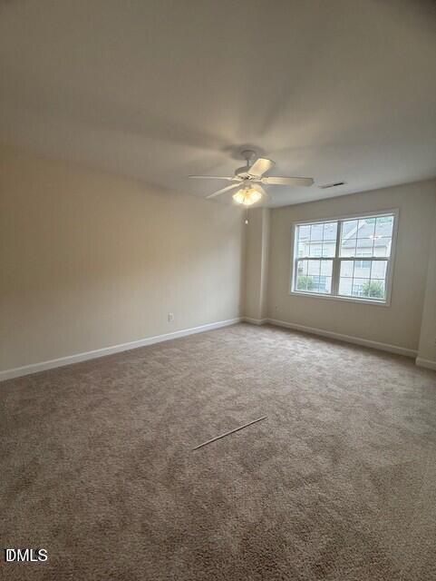4622 Centrebrook Circle Raleigh, NC 27616 - Photo 10 of 14 en empty room with windows and chandelier fan