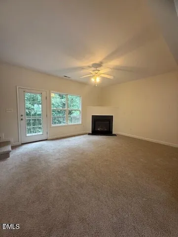 a view of a big room with an empty space and a window
