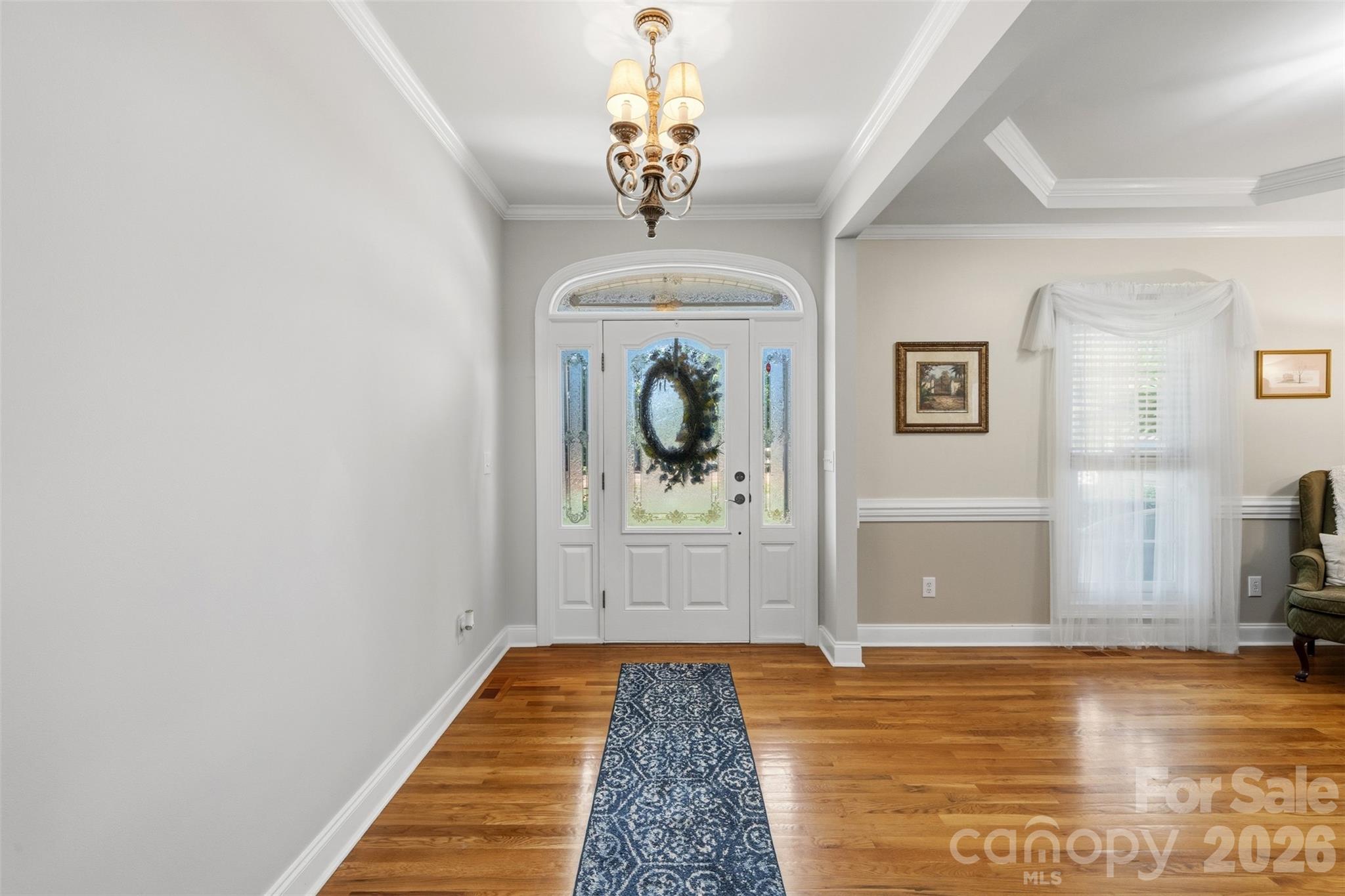 710 Sleepy Hollow Road Midland, NC 28107 - Photo 5 of 29 a bedroom with wooden floor closet and a chandelier