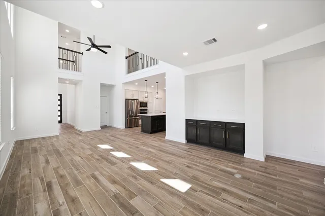 a view of empty room with wooden floor