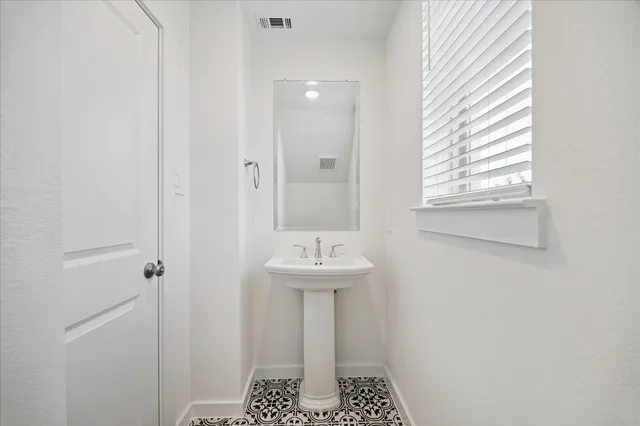 a bathroom with a sink a mirror and window