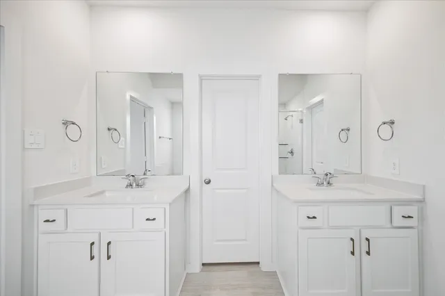 a bathroom with a sink double vanity and a mirror
