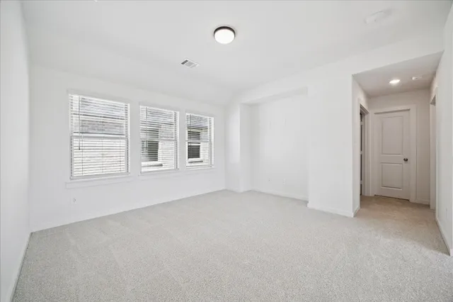 an empty room with windows and entrance