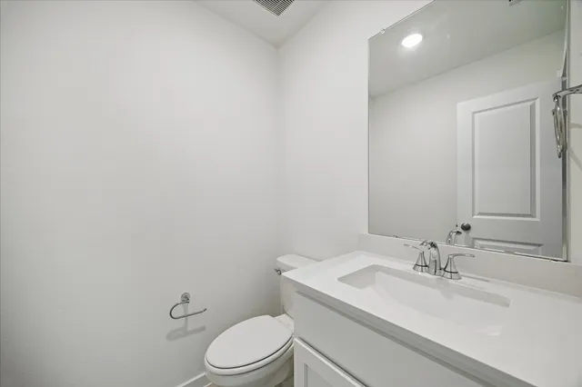 a bathroom with a sink a toilet and mirror