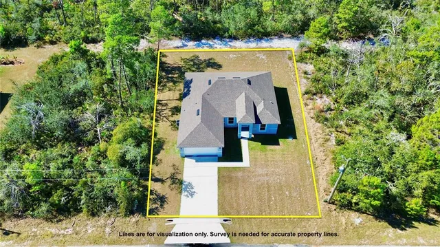 an aerial view of a house with a yard