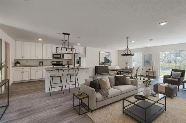 a living room with furniture and kitchen view