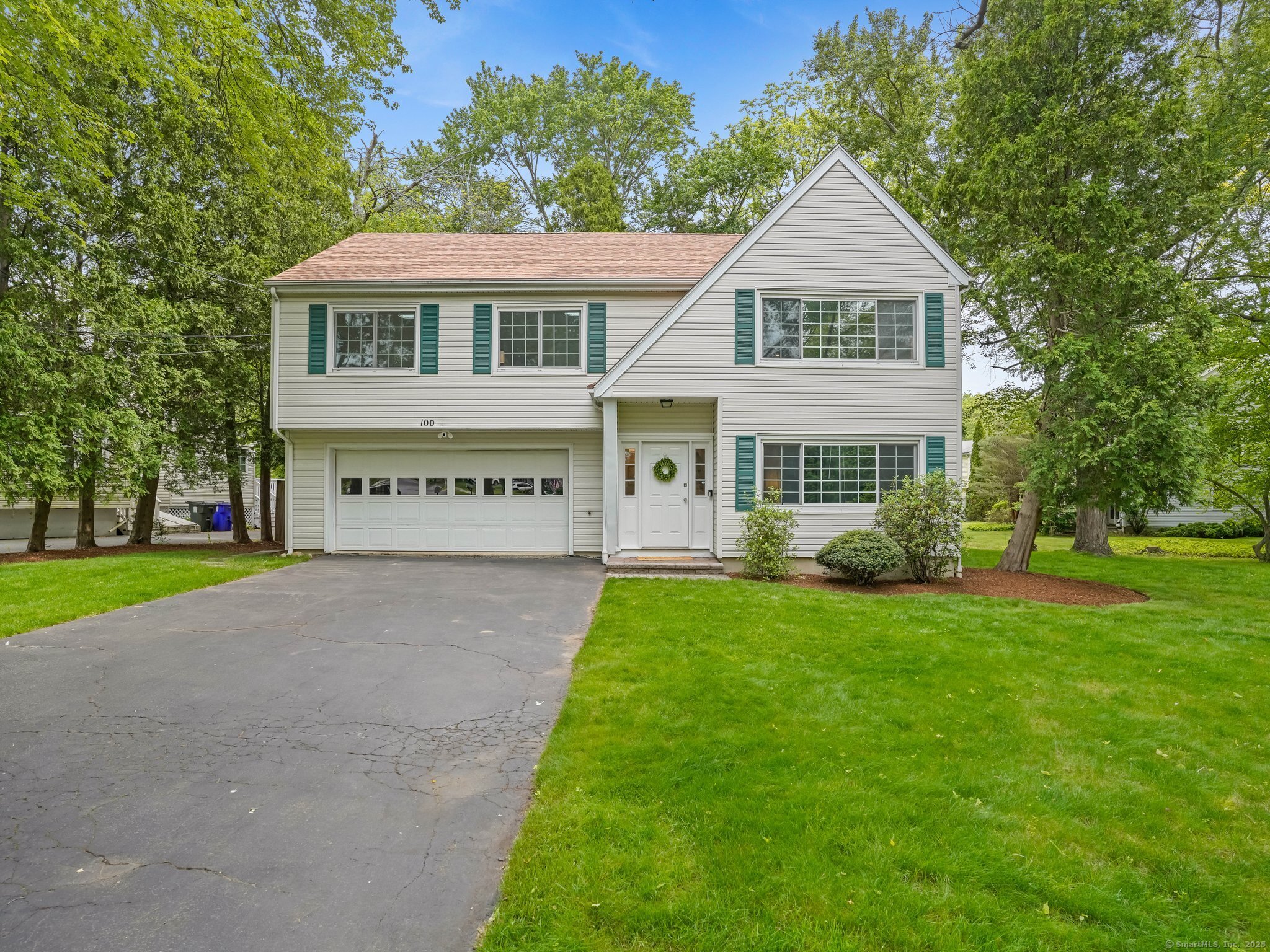 100 Mayfair Road Fairfield, CT 06824 - Photo 1 of 1 a view of a white house with a yard and large trees