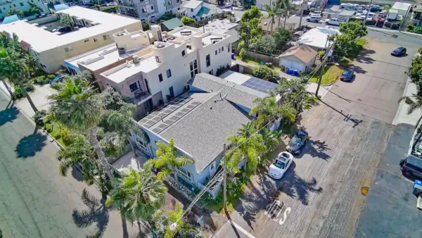 an aerial view of multiple houses with yard