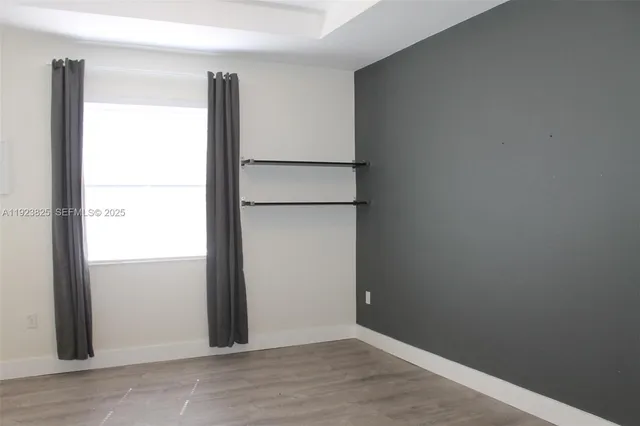 an empty room with wooden door