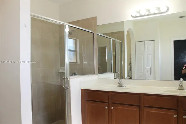 a bathroom with a sink double vanity and a mirror