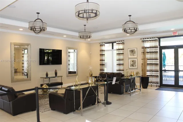 a living room with furniture a flat screen tv and windows