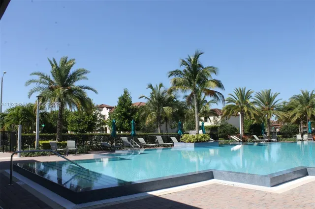 a view of a swimming pool with a table and chairs