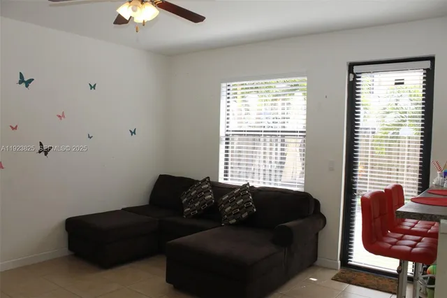 a living room with furniture and a large window