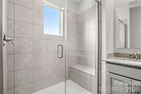 a bathroom with a shower and a sink