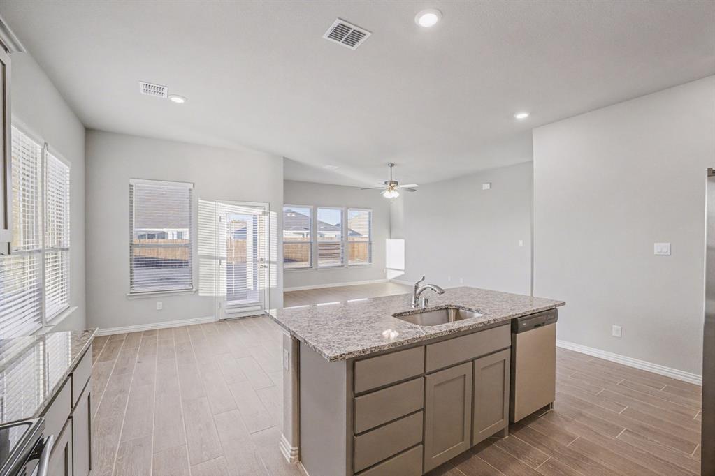 2404 Peebles Lane Denton, TX 76207 - Photo 13 of 30 a bathroom with a granite countertop sink and mirror