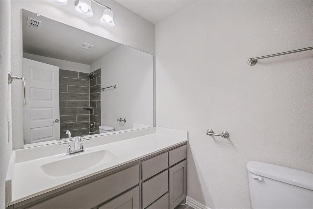 2404 Peebles Lane Denton, TX 76207 - Photo 27 of 30 a bathroom with a sink and a mirror