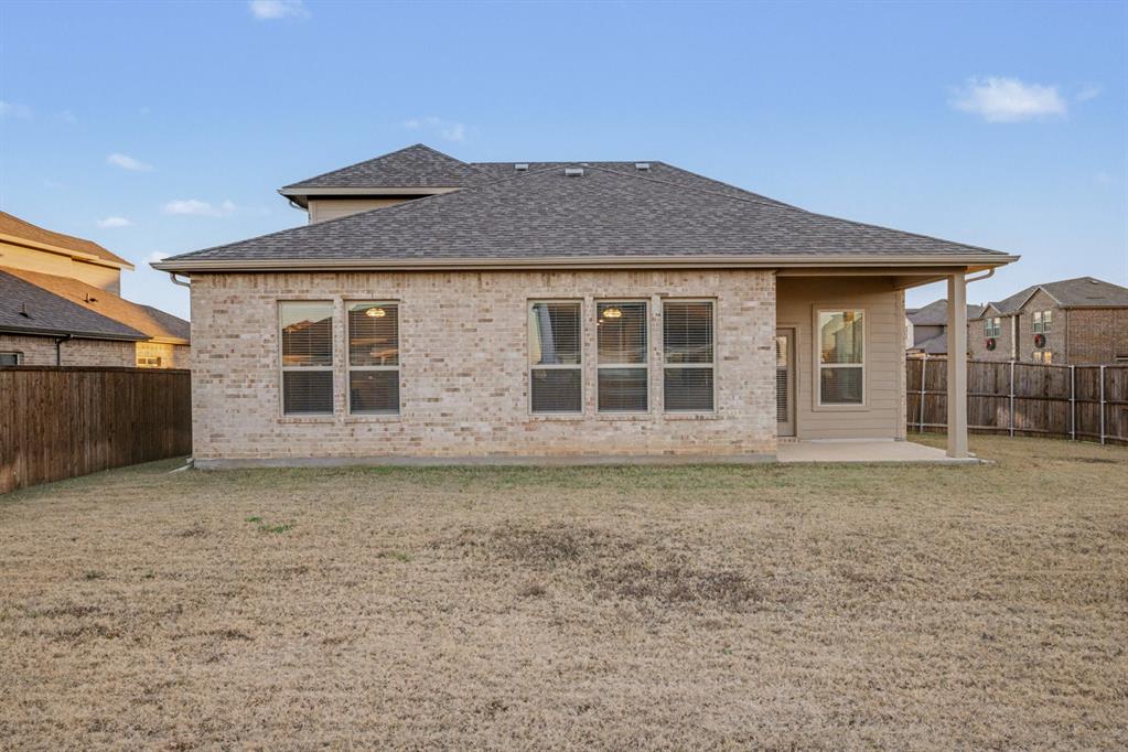 2404 Peebles Lane Denton, TX 76207 - Photo 29 of 30 a front view of a house with a garden