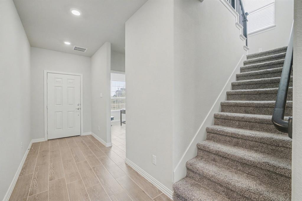 2404 Peebles Lane Denton, TX 76207 - Photo 4 of 30 a view of entryway with wooden floor