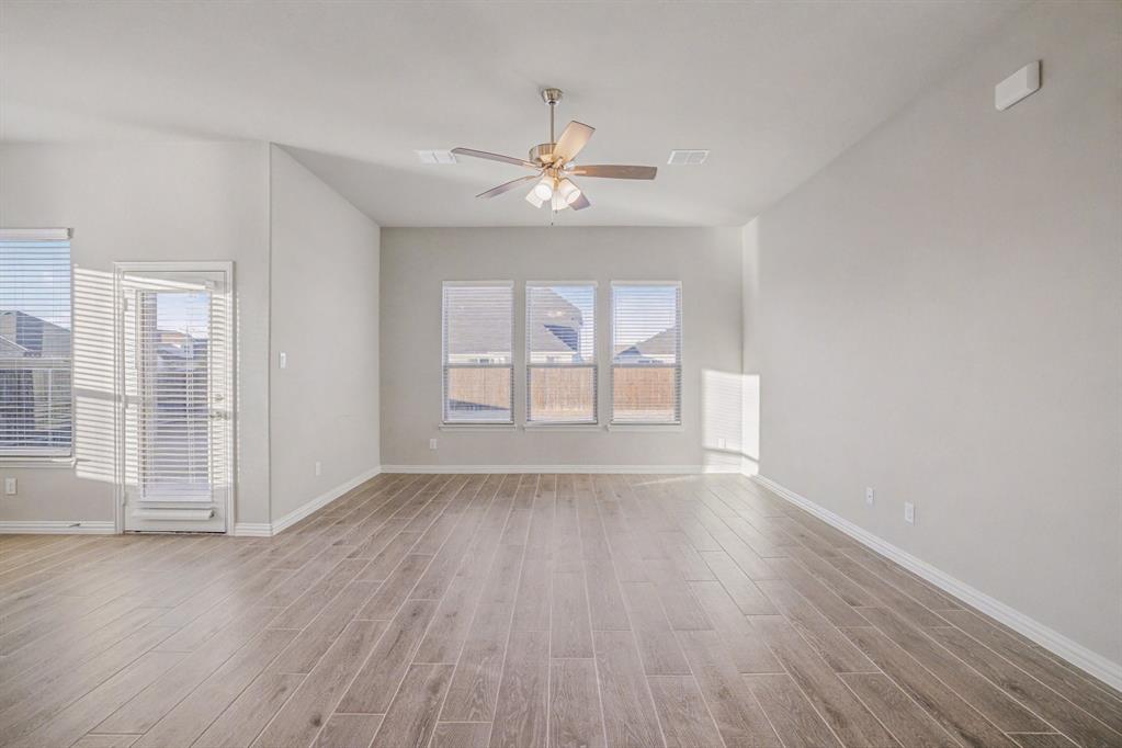 2404 Peebles Lane Denton, TX 76207 - Photo 5 of 30 wooden floor in an empty room with a window