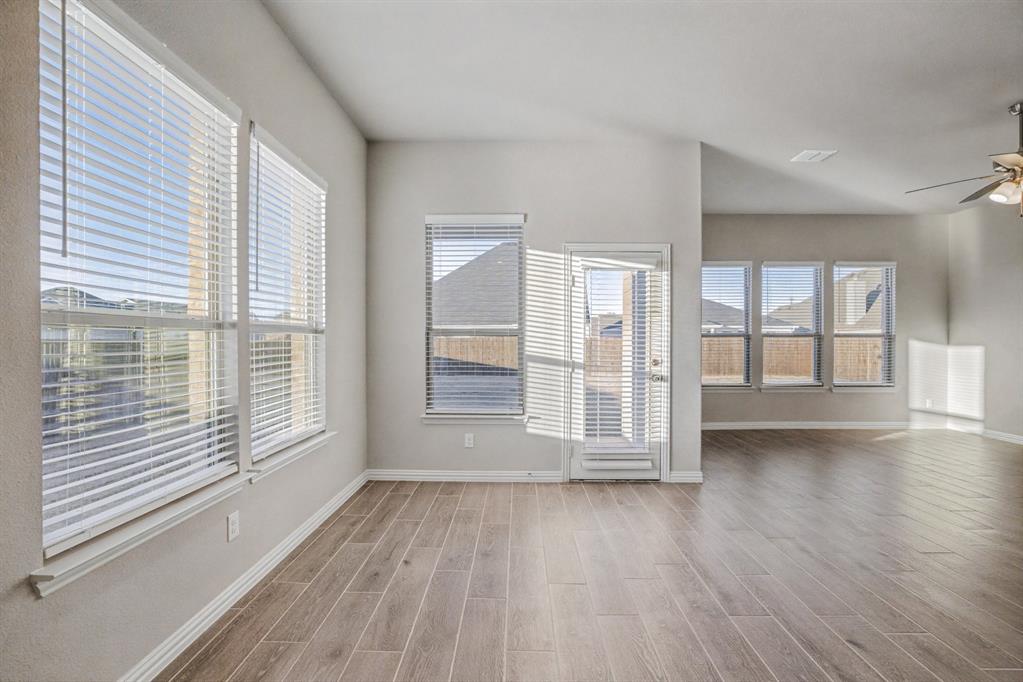 2404 Peebles Lane Denton, TX 76207 - Photo 7 of 30 wooden floor in an empty room with a window