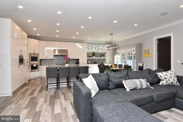 a living room with lots of furniture and kitchen view