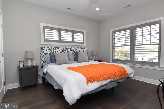 a bed sitting in a bedroom next to a window