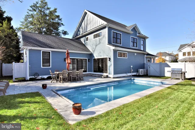 a view of a house with swimming pool and sitting area