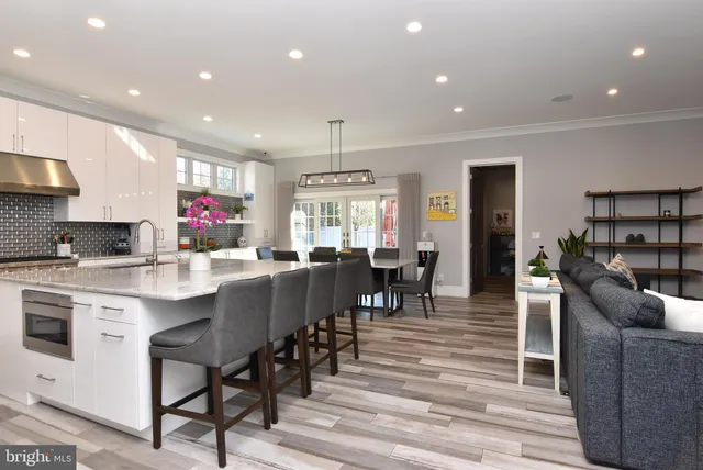 a view of kitchen with stainless steel appliances granite countertop cabinets table and chairs