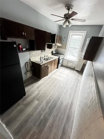 a living room with stainless steel appliances kitchen island granite countertop furniture a rug and a kitchen view