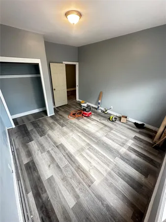a bed sitting in a bedroom next to a window