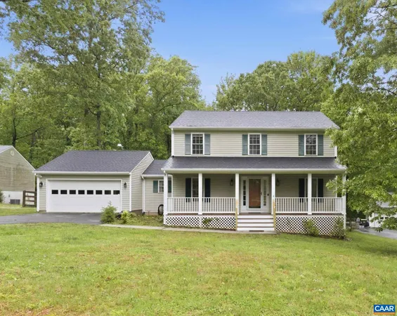 a view of a house with a garden and trees