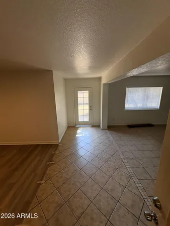 a view of empty room with window and fireplace