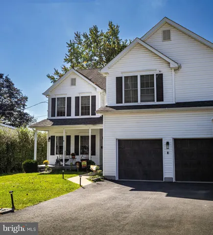 a front view of a house with a yard and porch