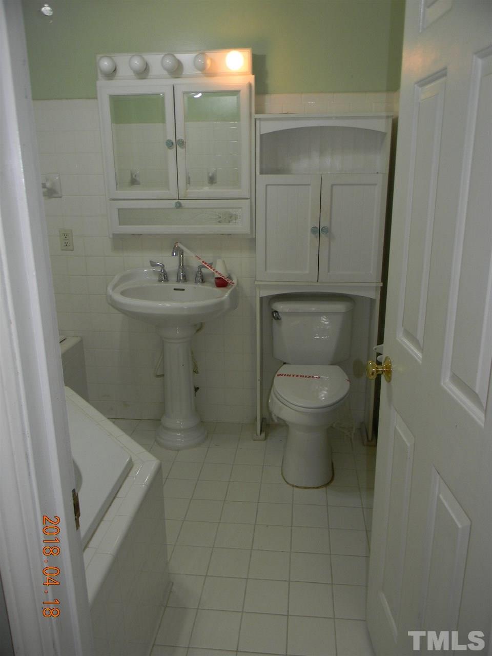 3309 Manor Ridge Drive Raleigh, NC 27603 - Photo 13 of 24 a bathroom with a sink toilet and a mirror
