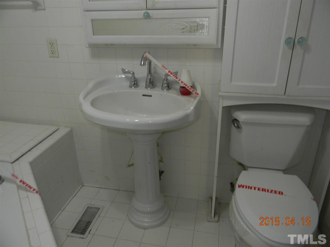 3309 Manor Ridge Drive Raleigh, NC 27603 - Photo 16 of 24 a bathroom with a toilet and a sink