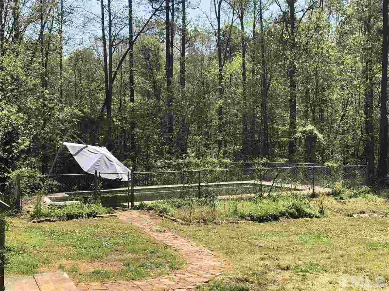3309 Manor Ridge Drive Raleigh, NC 27603 - Photo 23 of 24 a backyard of a house with a yard and outdoor seating