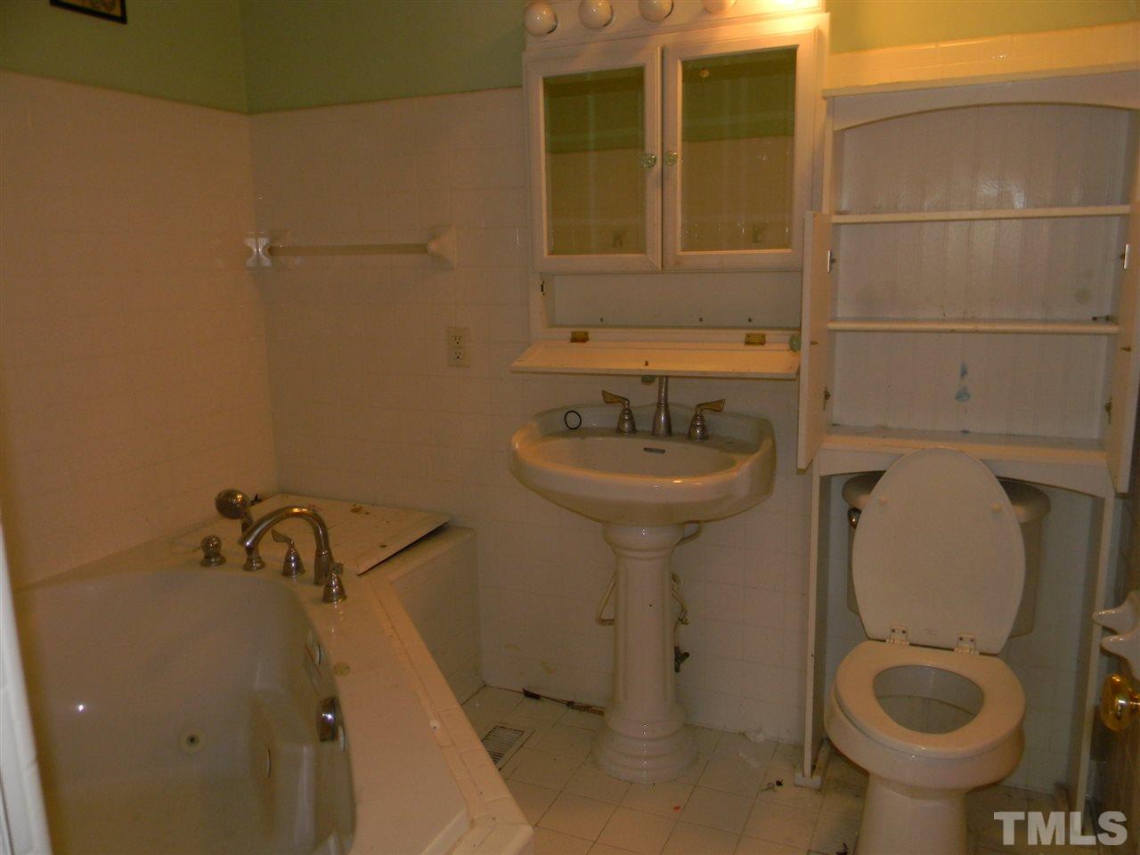 3309 Manor Ridge Drive Raleigh, NC 27603 - Photo 9 of 24 a bathroom with a sink and toilet