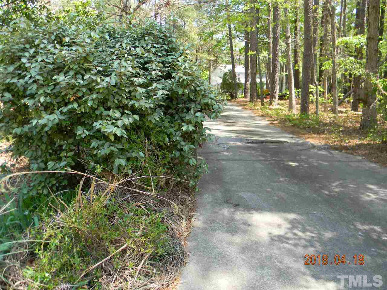 3309 Manor Ridge Drive Raleigh, NC 27603 - Photo 10 of 24 a view of a yard with plants and large trees