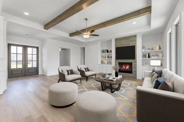 a living room with furniture a fireplace and a flat screen tv