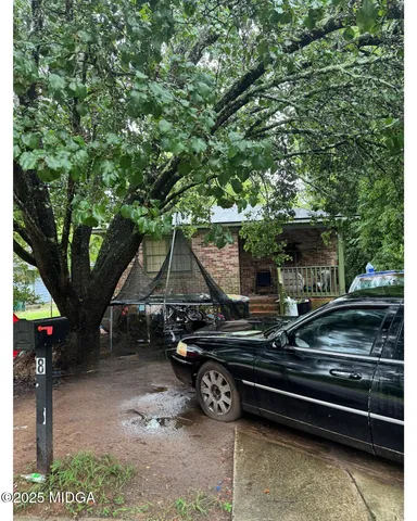 a view of a wooden chairs and table in the backyard