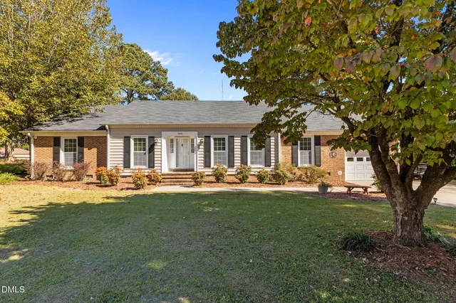 a front view of a house with swimming pool having outdoor seating