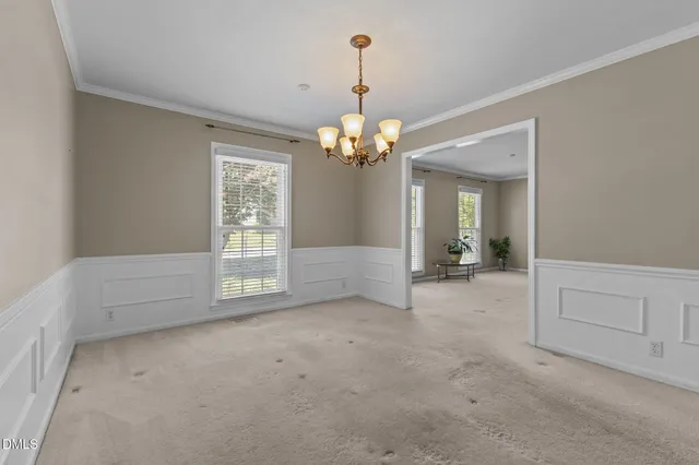 a kitchen that has a sink a window and stainless steel appliances