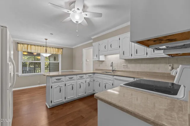 a kitchen with stainless steel appliances granite countertop a sink a stove and refrigerator