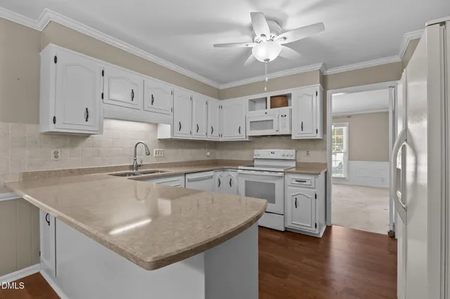 a kitchen with stainless steel appliances a sink stove and refrigerator